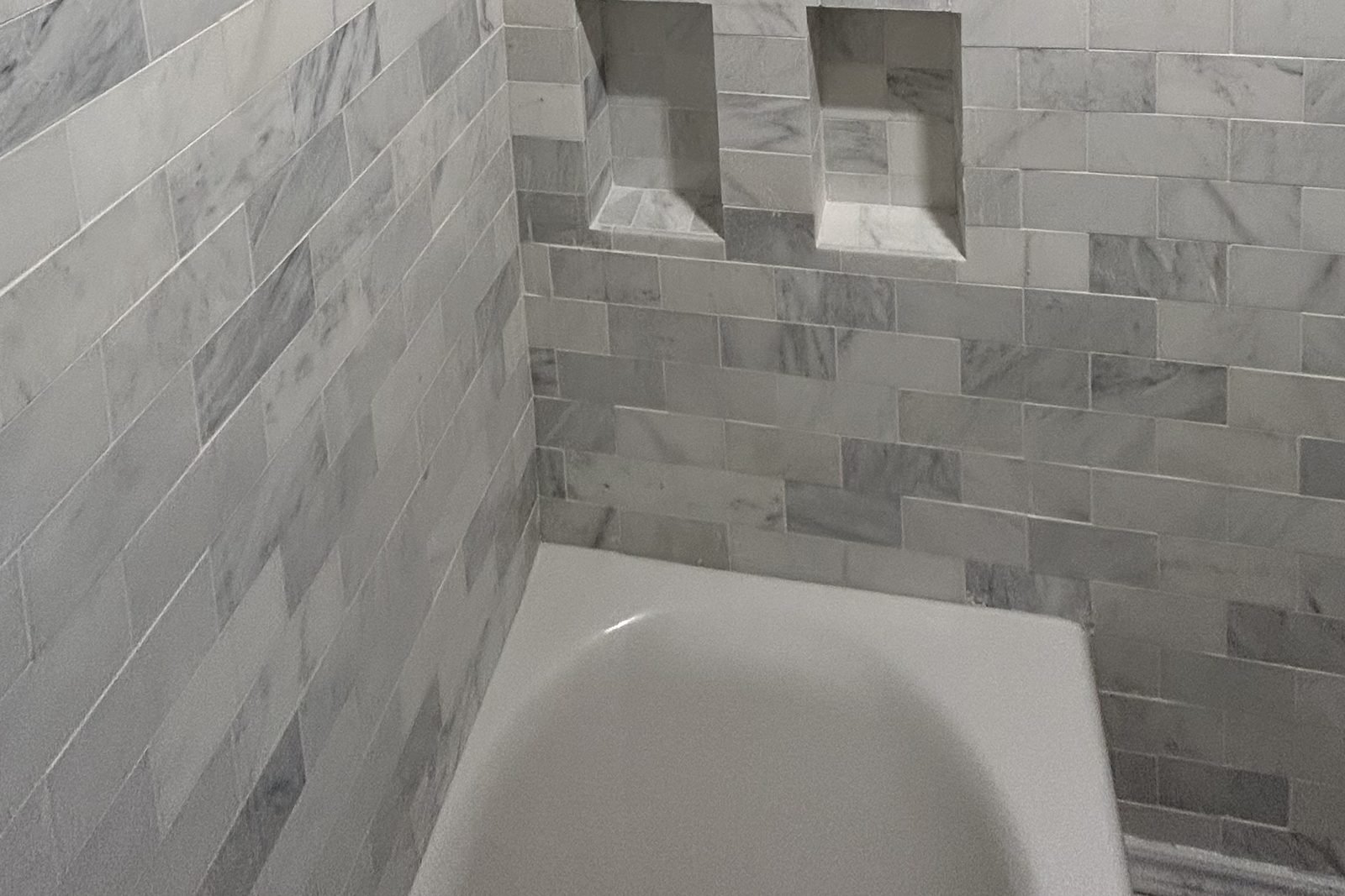 Marble tile shower with built-in niches